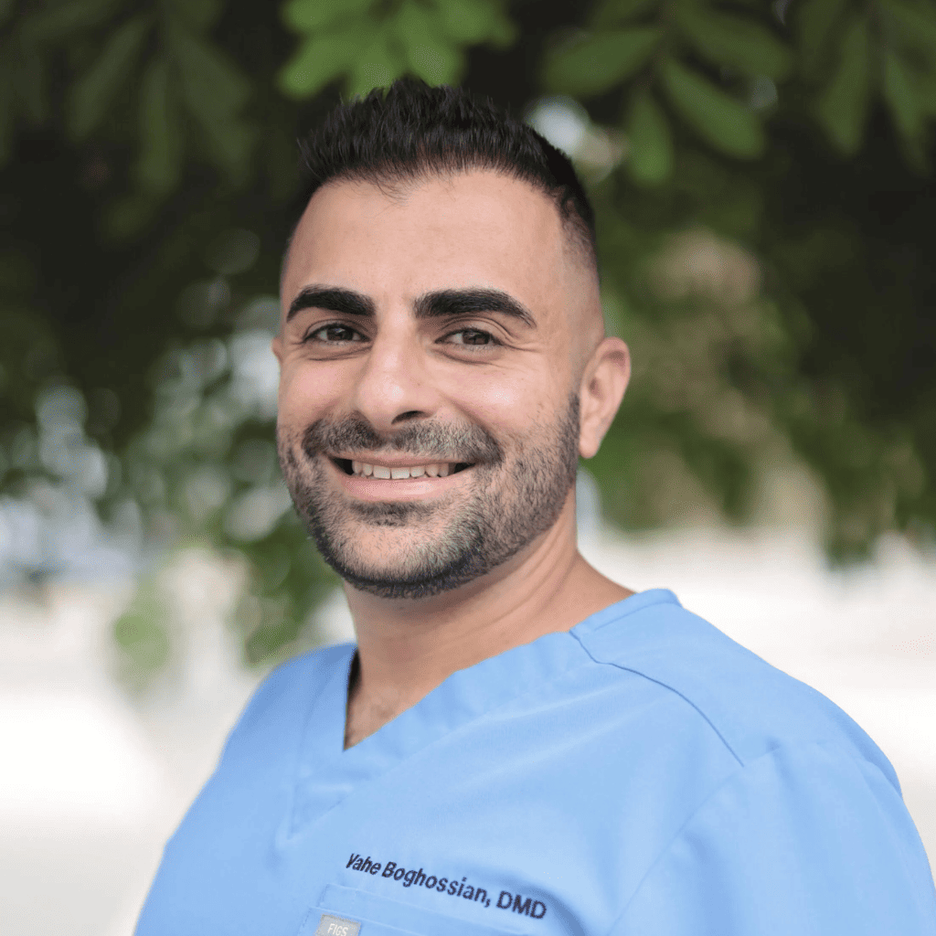 Dr. Vahe Boghossian, DMD, smiling in blue scrubs.